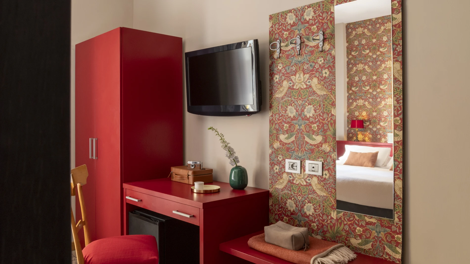 Triple room with single beds, red wall and minimalist furnishings, cozy atmosphere in Monti district Rome - Monti First, BZAR hotels in Rome