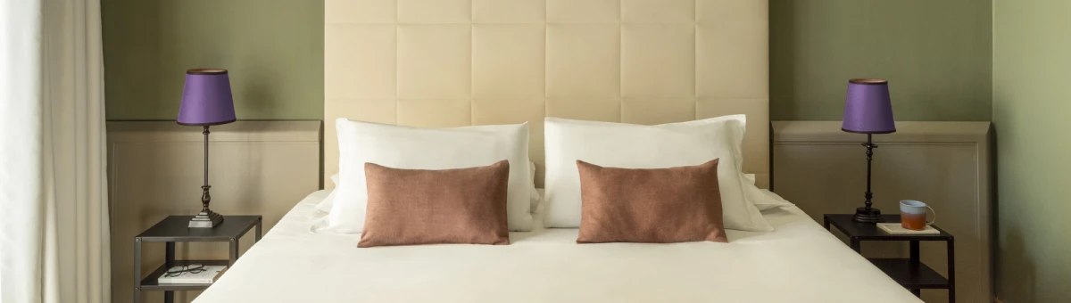 Standard room with double bed, upholstered headboard and soft lighting, elegant design in Monti district Rome - Monti First, BZAR hotels in Rome