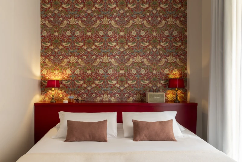 Elegant small room with red headboard, decorative wallpaper and warm lighting, in the heart of Monti district in Rome - Monti First, BZAR hotels in Rome