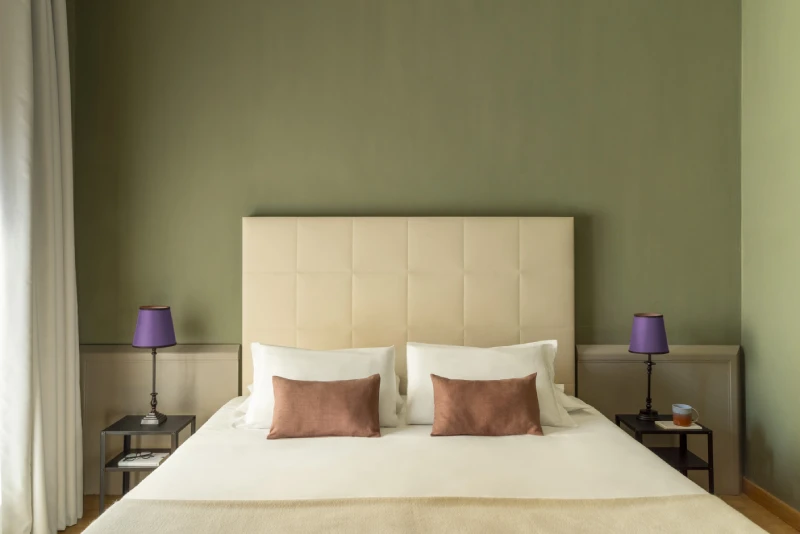 Standard room with double bed, upholstered headboard and soft lighting, elegant design in Monti district Rome - Monti First, BZAR hotels in Rome