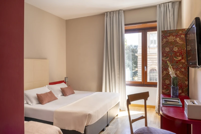Bright triple room with double and single bed, window overlooking historic building in Monti district Rome - Monti First, BZAR hotels in Rome